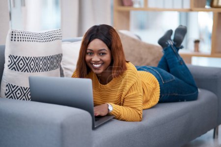 Photo for Black woman with laptop, portrait and relax on sofa, search online for movie and streaming subscription at home. Happy African female person in apartment, connectivity and watching on pc with web. - Royalty Free Image