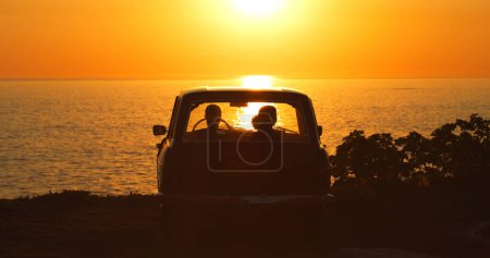Photo for Beach, silhouette and people in car at sunset for freedom, travel or road trip together. Dark, summer and friends in transport in the evening at the ocean for a date, vacation or adventure by the sea. - Royalty Free Image
