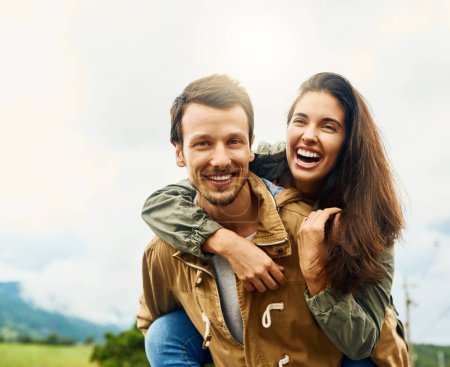Laugh, love and piggyback with portrait of couple in nature for happy, smile and bonding. Happiness, relax and care with man carrying woman on countryside date for spring, vacation and support.