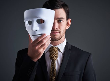 Photo for Two faced portrait, mask and fake businessman in a studio with serious face with secret personality. Manager and corporate male with rope tie showing corporate slavery and control in business suit. - Royalty Free Image