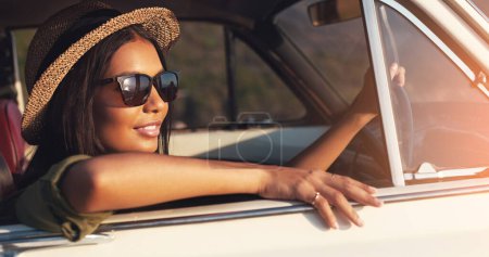Photo for Road trip, car window and flare with a woman enjoying travel or freedom on a joy ride as a tourist. View, sunset and relax with a young female traveler taking a drive alone outdoor for adventure. - Royalty Free Image