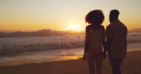 Photo for Man with woman holding hands, beach at sunset and sea with back view, mockup space and travel with couple outdoor. Love, romance and trust with people in commitment, tropical holiday and ocean waves. - Royalty Free Image