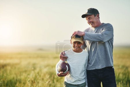 Photo for Father, kid smile and rugby ball in a countryside field for bonding and fun in nature. Mockup, dad and young child together with happiness ready to start game outdoor on grass at farm with space. - Royalty Free Image