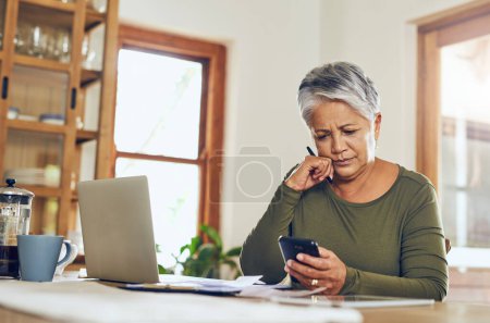 Photo for Senior woman, phone budget planning and health insurance checklist at home. Writing, contract and elderly female person with mobile banking, tax and pension form in a house with bills and debt. - Royalty Free Image