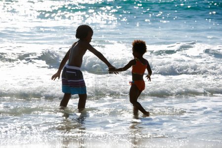 Photo for Best big brother ever. A brother and sister playing together on the beach - Royalty Free Image