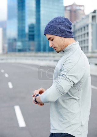 Photo for Rush hour is a long way off. a young jogger checking the time while out for a run in the city - Royalty Free Image