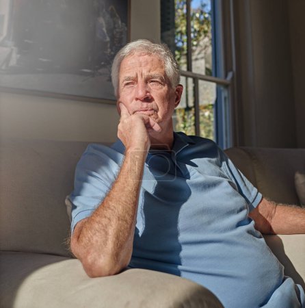 Photo for Lonely senior man thinking in home, couch and lounge about future anxiety, remember memory and alzheimer. Retirement, elderly male and nostalgia memories on sofa, depression and dementia in isolation. - Royalty Free Image