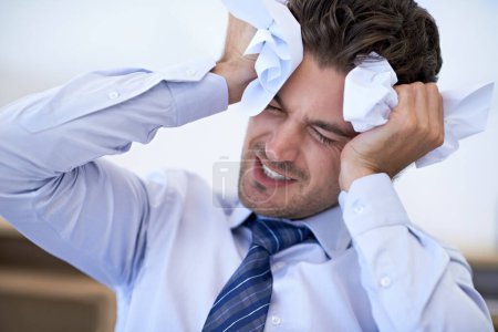 Photo for I cant take another minute of this work. Cropped view of a stressed businessman holding crumpled paper to his head - Royalty Free Image