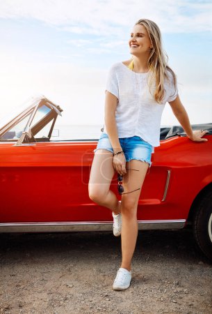 Photo for The world has lots of stories to tell. a happy young woman enjoying a summers road trip - Royalty Free Image