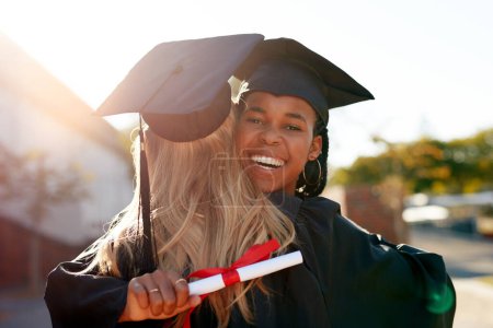 Photo for Hug, students and graduation for college or university friends together for congratulations. Portrait of black woman outdoor to celebrate education achievement, success or certificate at school event. - Royalty Free Image