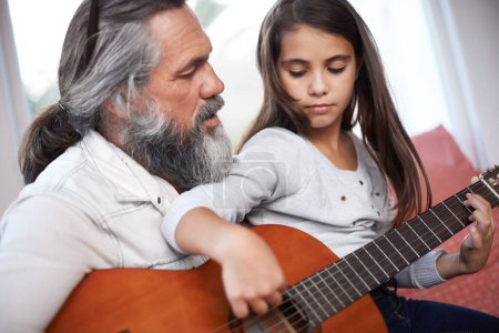 Photo for Music, guitar and grandfather teaching girl to play, help with creativity, learning and creative development. Musician, senior man helping female kid learn focus and skill on musical instrument. - Royalty Free Image