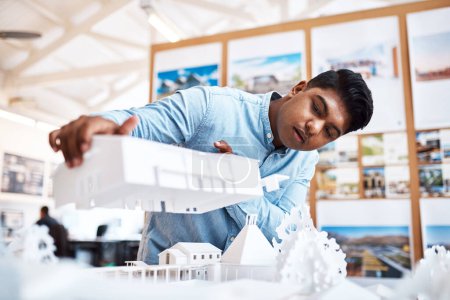 Photo for Building design thats as functional as it is innovative. a young architect designing a building model in a modern office - Royalty Free Image