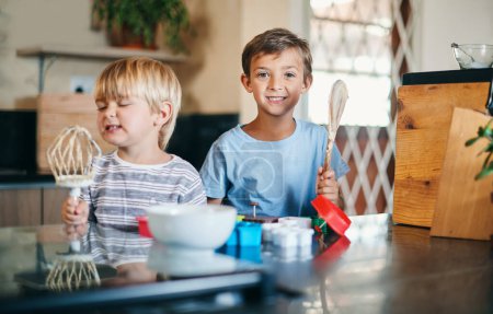 Photo for We make the best cookies by far. two adorable little boys baking together at home - Royalty Free Image
