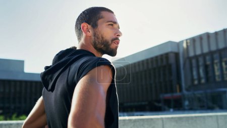 Photo for Willpower is the secret to fitness success. a young man going for a workout in the city - Royalty Free Image