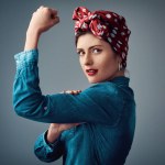Flexing, strong and portrait of a pinup girl with muscle in studio for support, women power and fashion. Female person show bicep on grey background for motivation, freedom and retro or vintage style.