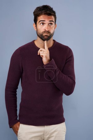 Photo for Thinking, wonder and man in studio with unsure, uncertain and thoughtful on gray background in studio. Doubt mindset, mockup space and face of male person thoughtful for decision, choice and question. - Royalty Free Image