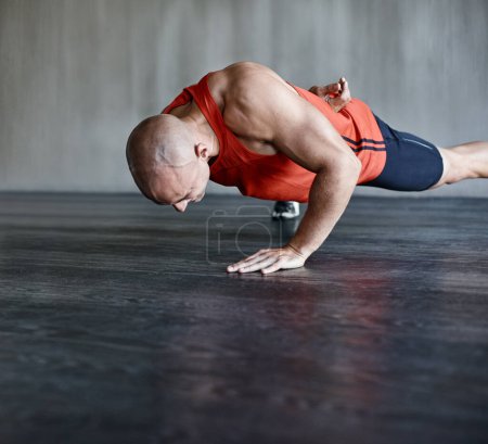 Photo for Training, muscle strength and strong man doing push up for studio floor performance, gym routine or health club commitment. One arm pushup, motivation and male person workout, exercising or fitness. - Royalty Free Image