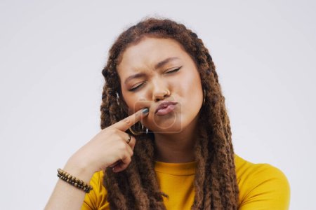 Photo for Finger, funny face and pout with a black woman joking in studio on a white background for humor. Comic, comedy and duckface with a pouting young female person feeling playful while having fun. - Royalty Free Image