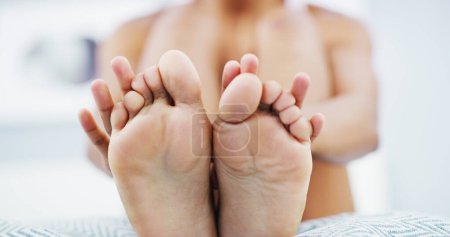 Photo for Skincare, moisturizer and feet of woman on bed for smooth, pedicure or healthy skin at home. Dermatology, podiatry and closeup of foot of female person for body care, wellness and health in bedroom. - Royalty Free Image