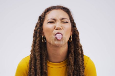 Photo for Portrait, funny face and tongue with a black woman joking in studio on a white background for humor. Comic, comedy and braids on eyes with a playful young female person eyes closed for an emoji. - Royalty Free Image