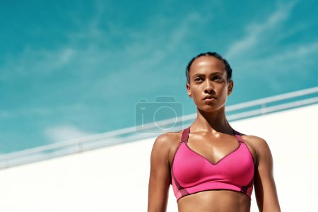 Photo for Exercise, fitness and serious woman with blue sky mock up at outdoor gym for health and wellness with focus on goals. Workout, sports model and athlete with sweat, healthy mindset and fit summer goal. - Royalty Free Image