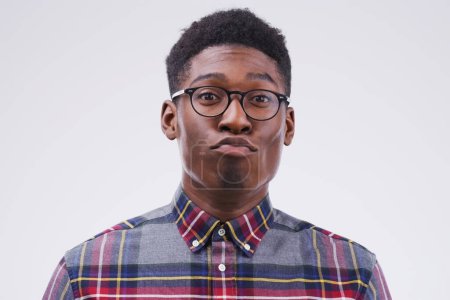 Photo for Funny face, young and portrait of a black man pouting isolated on a white background in a studio. Geek, pout and a face headshot of an African person with glasses as a nerd, goofy and quirky. - Royalty Free Image