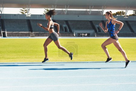 Photo for Woman, running and stadium track of athletes in competition, fitness or athletics in the outdoors. Fit, active or sporty women, runner or sprinting in exercise, workout or training for healthy cardio. - Royalty Free Image