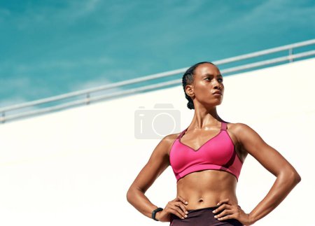 Photo for Sports, serious fitness and woman with mockup, blue sky at outdoor gym for health and wellness. Workout, exercise and power, athlete with focus and mock up space for healthy mindset for summer goals - Royalty Free Image