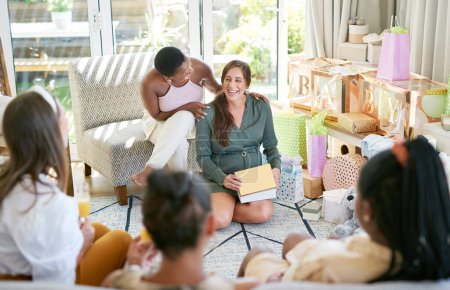Photo for This is the best present yet. a young mother opening a gift from her friends at her baby shower - Royalty Free Image