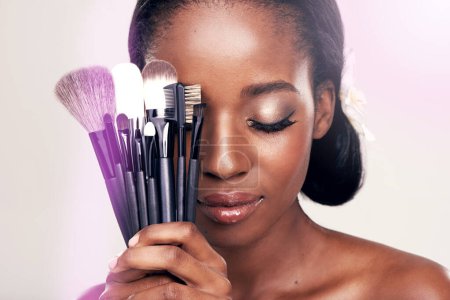 Photo for Beauty, makeup and brushes, black woman in studio with cosmetic application tools and glamour. Skincare, brush and cosmetics, facial skin care glow, model with luxury contour tool on white background. - Royalty Free Image