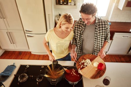 Photo for Top view, food or happy couple in a kitchen cooking with healthy vegetables for dinner meal together at home. Love or woman helping or talking to mature husband in lunch diet preparation in Australia. - Royalty Free Image