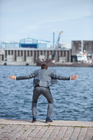 The temptation to quit is strongest before you succeed. Full length shot of an unrecognizable businessman standing on the dock and wanting to jump into the water
