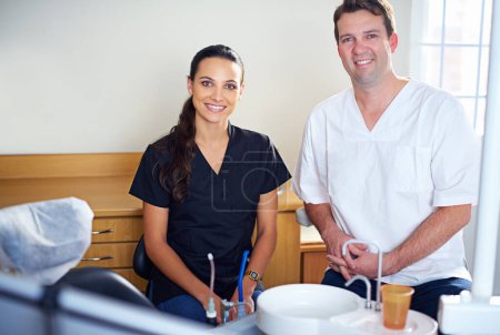 Photo for Im sure youre cavity free. Cropped portrait of a dentist standing with his assistant - Royalty Free Image