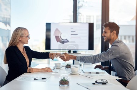 Photo for Deal with get it done people. a young businesswoman and businessman shaking hands during a meeting in a modern office - Royalty Free Image