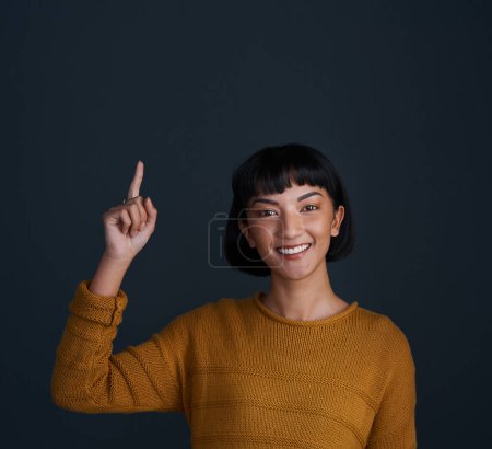 Photo for Woman is pointing up, marketing and mockup space with portrait, smile and promo isolated on blue background. Young female person, happy ambassador and branding with advertising and show in studio. - Royalty Free Image