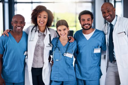 Photo for There is no other better team around. Portrait of a cheerful group of doctors standing with their arms around each other inside of a hospital during the day - Royalty Free Image