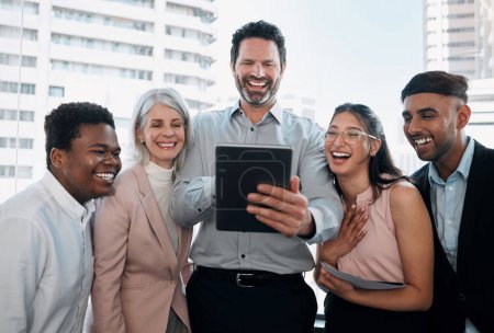 Photo for Yup, we did that. a diverse group of businesspeople standing in the office together and using a digital tablet - Royalty Free Image