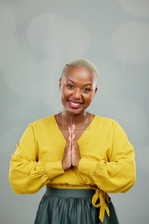 Photo for Praying hands, thank you and portrait of happy woman in studio with gratitude sign on wall background. Face, together hand and smile by female person showing space, prayer and worship emoji icon. - Royalty Free Image