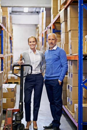 Photo for Weve got your order right here. Portrait of a man and woman inspecting inventory in a large distribution warehouse - Royalty Free Image