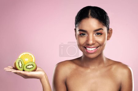 Foto de Haz bien la combinación. Estudio de una hermosa joven posando con fruta en la mano - Imagen libre de derechos