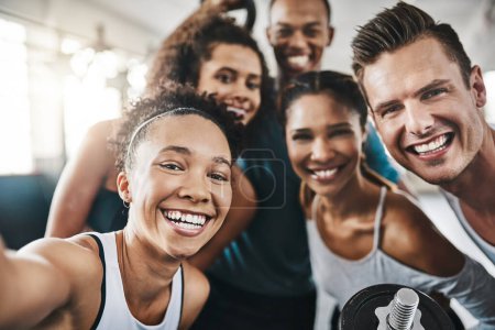 Photo for Adding the fun factor to fitness. a group of young people taking a selfie together during their workout in a gym - Royalty Free Image