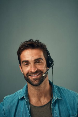 Photo for Happy man, call center and consultant with headphones on mockup space against grey studio background. Portrait of friendly male consulting agent with smile and headset in contact us for online advice. - Royalty Free Image
