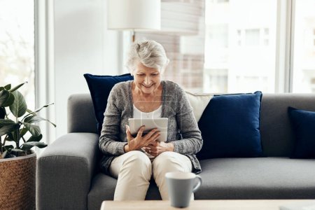 Photo for A tech savvy granny is much more involved. a senior woman using a digital tablet while relaxing at home - Royalty Free Image
