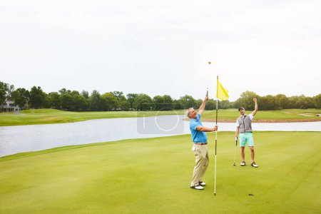 Photo for The thrill of hitting a good shot. two friends out playing golf together in their free time - Royalty Free Image