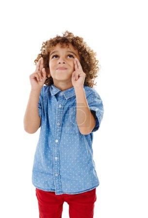 Photo for Dream it. Wish it. Do it.Studio shot of a cute little boy wishing for something with his fingers crossed against a white background - Royalty Free Image