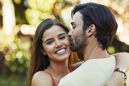 Photo for His kisses are the sweetest. Portrait of an affectionate young couple sharing a kiss outside - Royalty Free Image