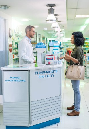 Photo for Pharmacists are educated to recognize signs and symptoms of diseases. a mature pharmacist assisting a young woman in a chemist - Royalty Free Image