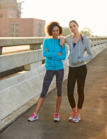 Photo for Were a picture of perfect jogging health. Portrait of two female joggers standing in the road before a run through the city - Royalty Free Image