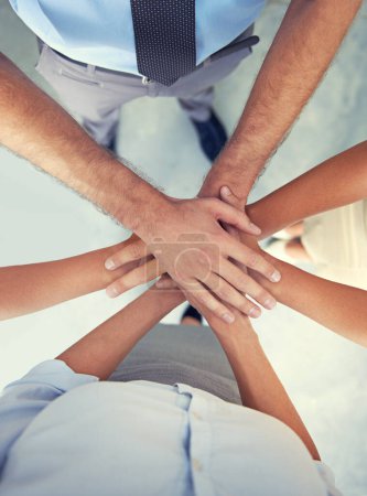 Photo for Top view, hands and team of business people with motivation, support and winning in success, target and trust. Hand huddle, stack and group cooperation for mission, partnership goals and faq about us. - Royalty Free Image