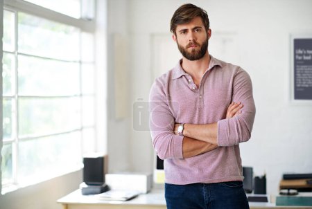 Photo for I wont except anything less than success. Cropped portrait of a businessman standing with his arms folded in the office - Royalty Free Image
